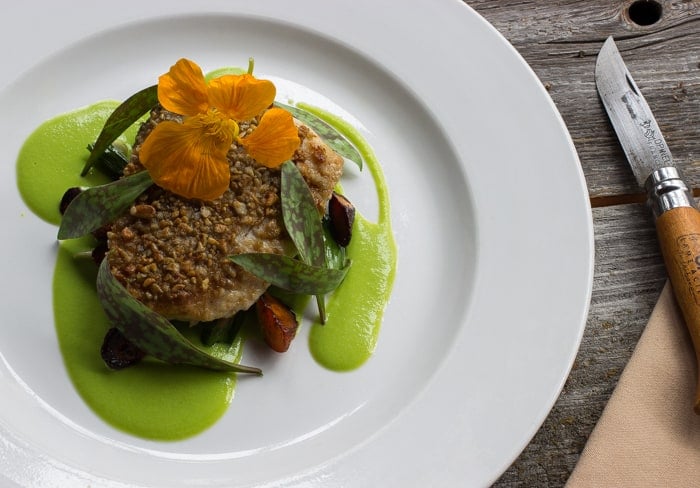 Sunflower seed crusted whitefish with two lillies, peas and carrots