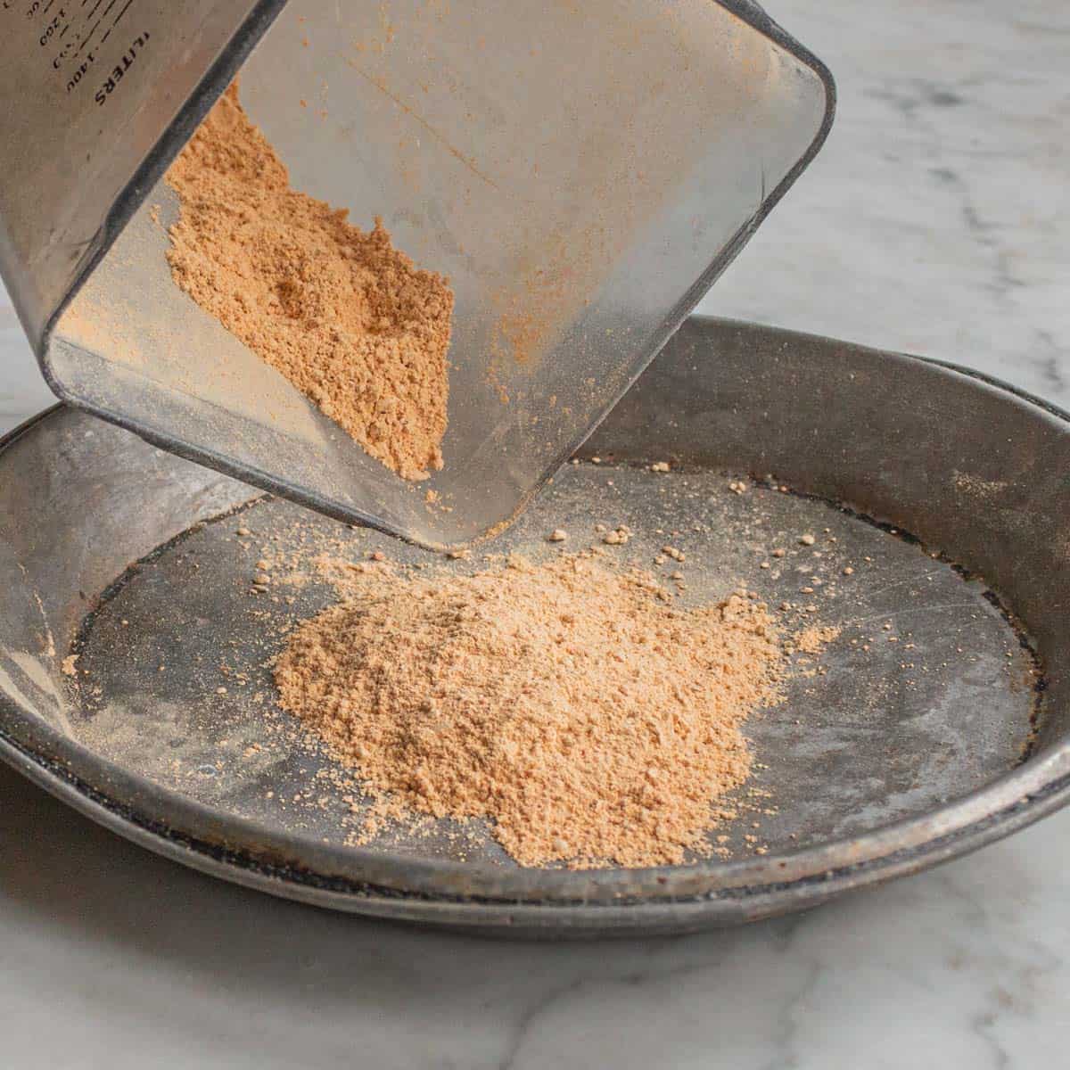 a vitamix blender with lobster mushroom powder pouring onto a plate. 