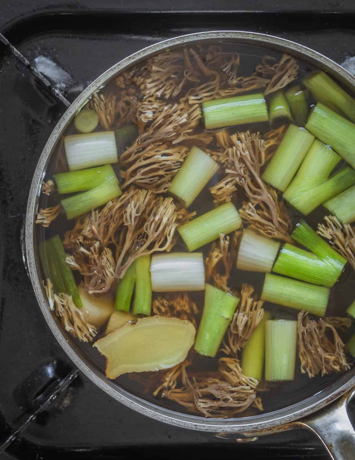 Cooking crown tipped coral mushroom soup. 