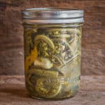 Crunchy pickled ostrich fern fiddleheads in a jar.