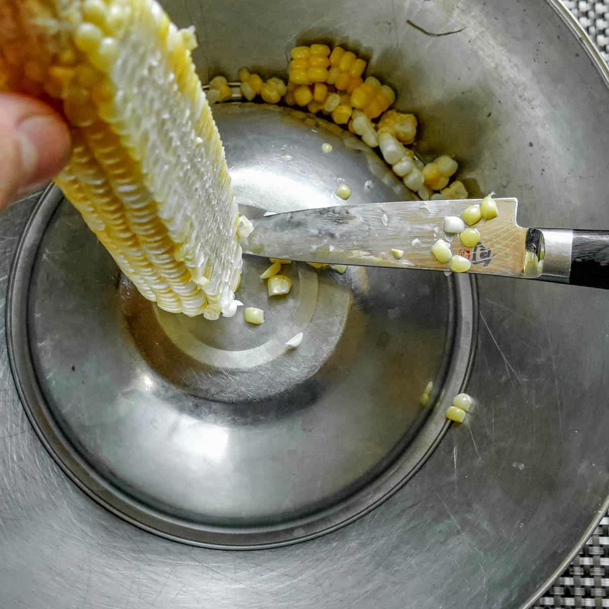 cutting sweet corn using two bowls 