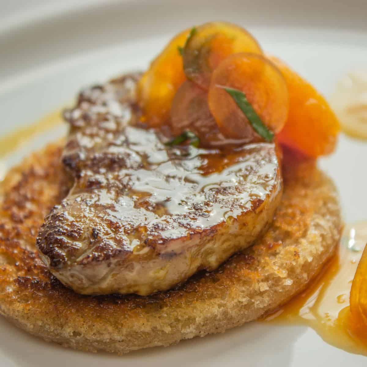 a slice of seared foie gras on toast with fruit sauce