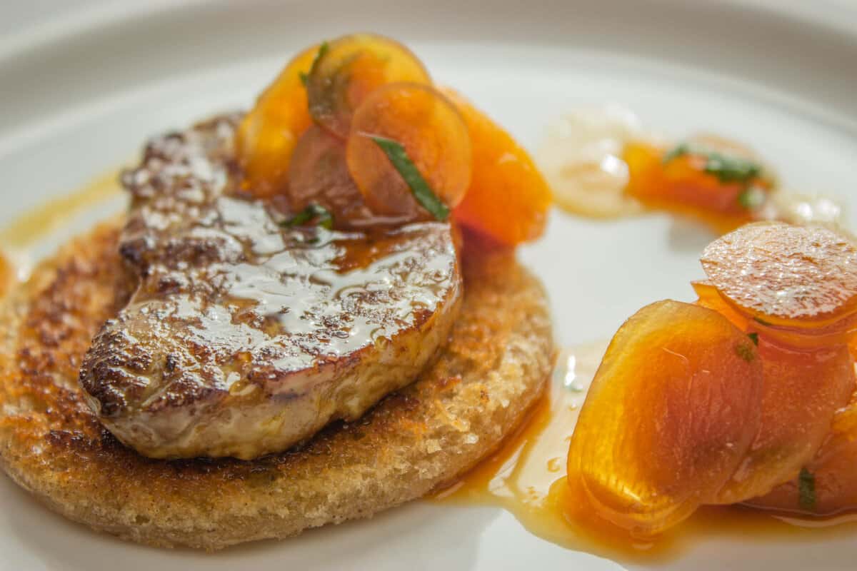 a slice of seared foie gras on toast with fruit sauce 