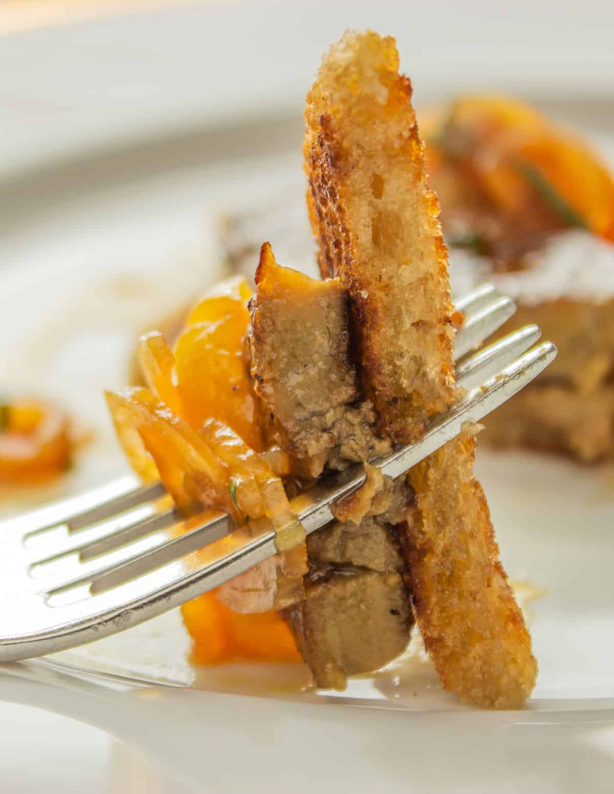 a bite of foie gras, apricot, and toast on a fork