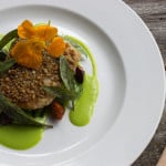 Sunflower seed crusted whitefish with two lillies, peas and carrots