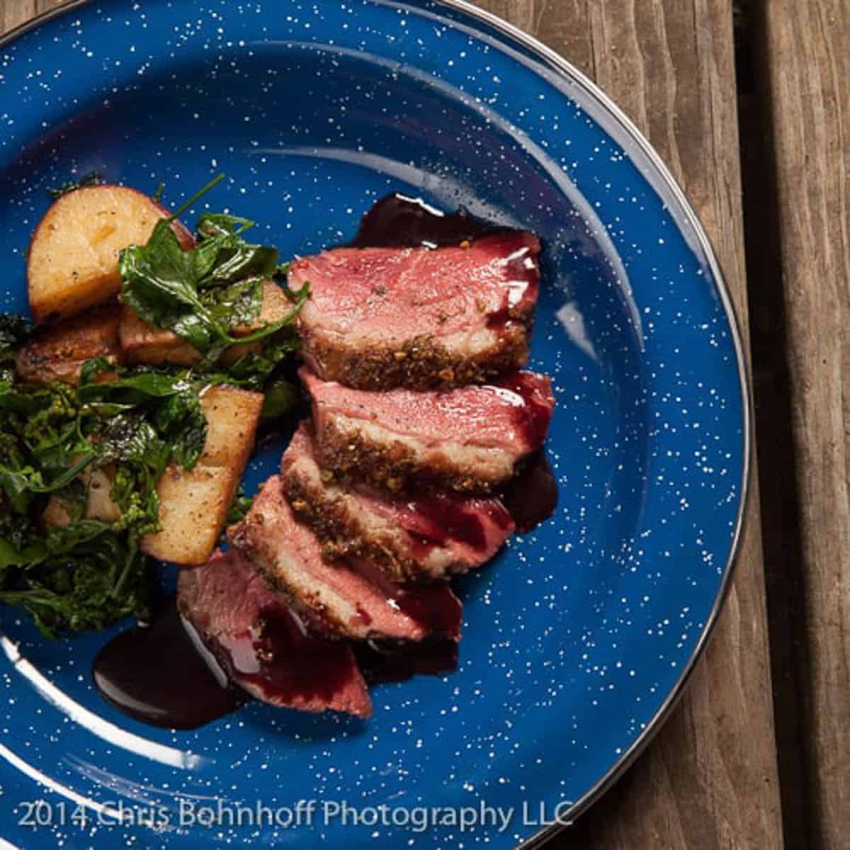 duck breast with wild juniper, black cap berry sauce, duck fat potatoes and wild spinach