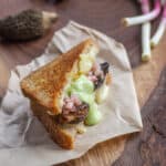 mushroom sandwich with morels and green aioli cut in half