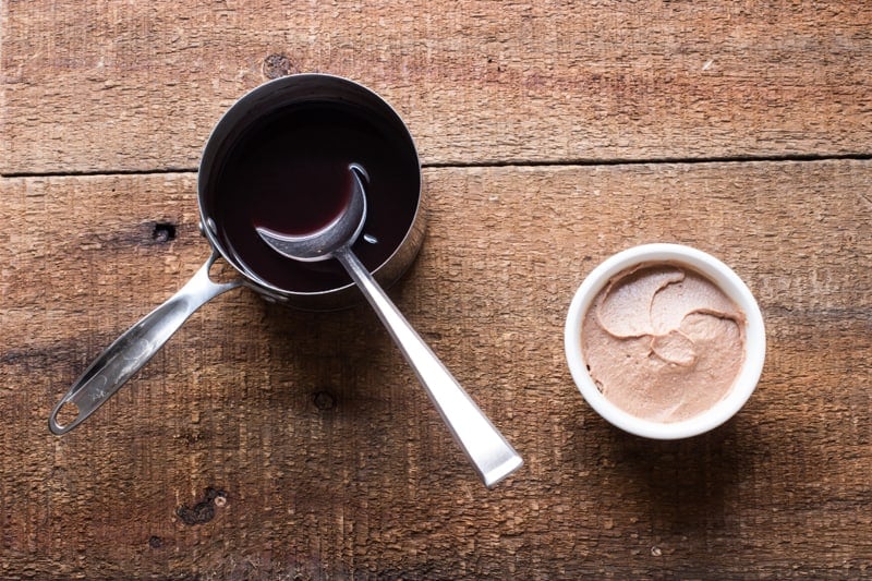 topping a ramekin of liver mousse with jelly 