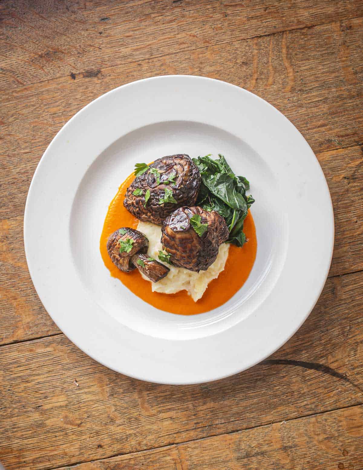 Pan-roasted shaggy parasol mushroom caps with tomato coulis and semolina pudding. 