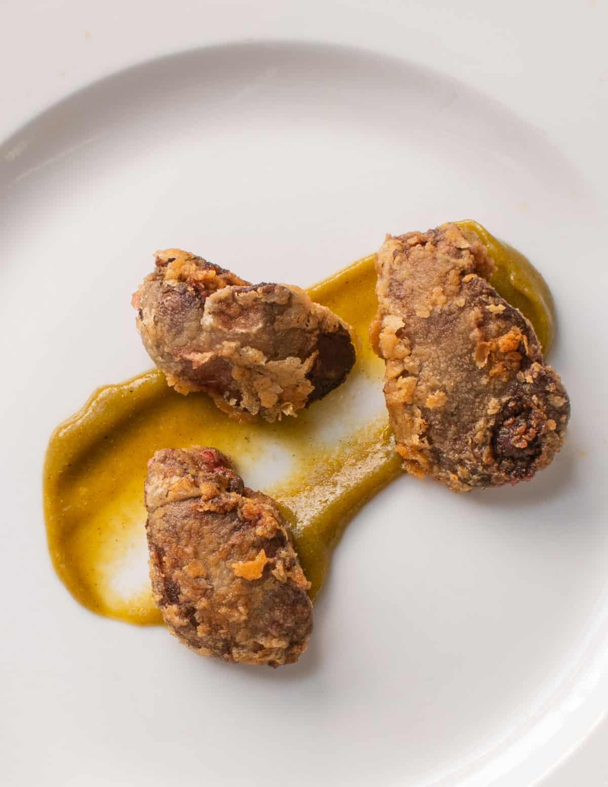 fried chicken livers with green tomato jam on a plate