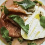 a plate of cured meats and sliced mushrooms