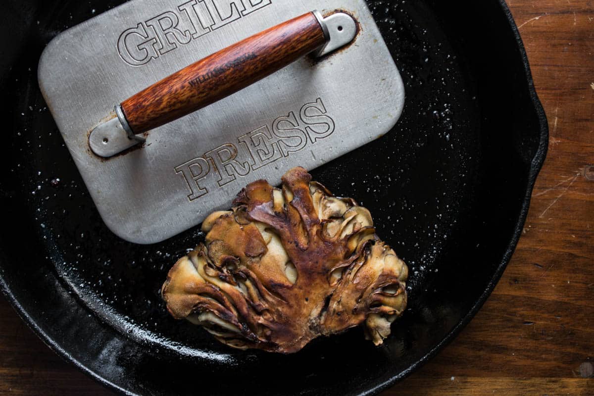 Hen of the woods mushrooms or maitake cooked under a brick