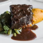 Bison braised in wild grape juice with kabocha squash puree and collards