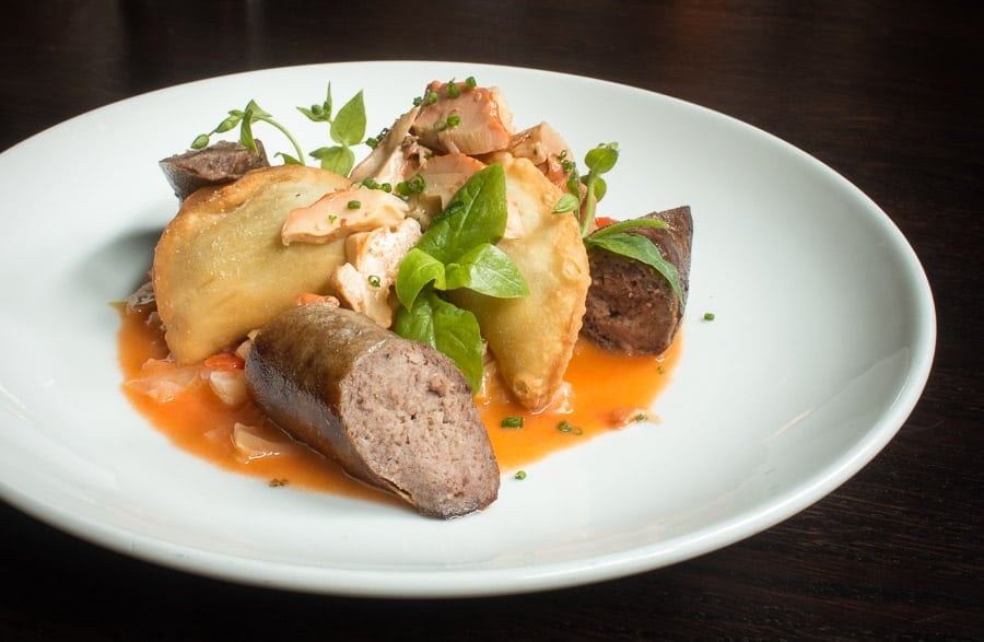 fermented ramp pierogi with chickweed, bratwurst, and chicken of the woods