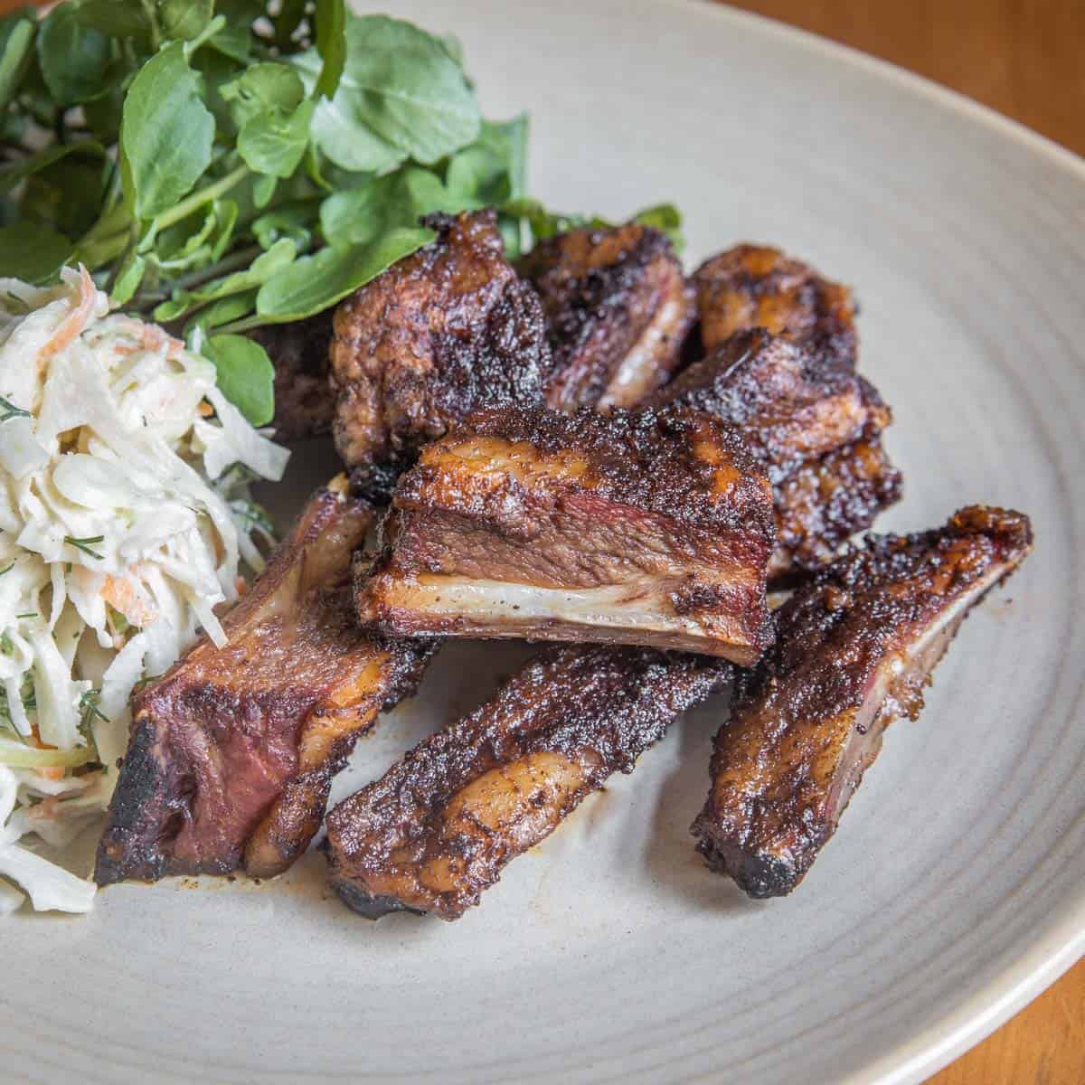 lamb ribs on a plate with slaw