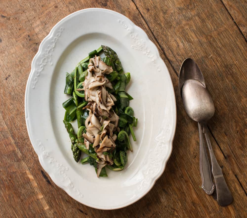 Asparagus and fiddleheads with shaved dryad saddle mushrooms