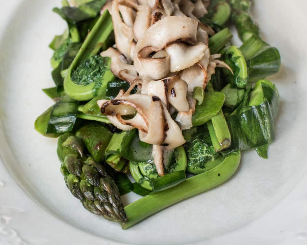 Asparagus and fiddleheads recipe with shaved dryad saddle mushrooms