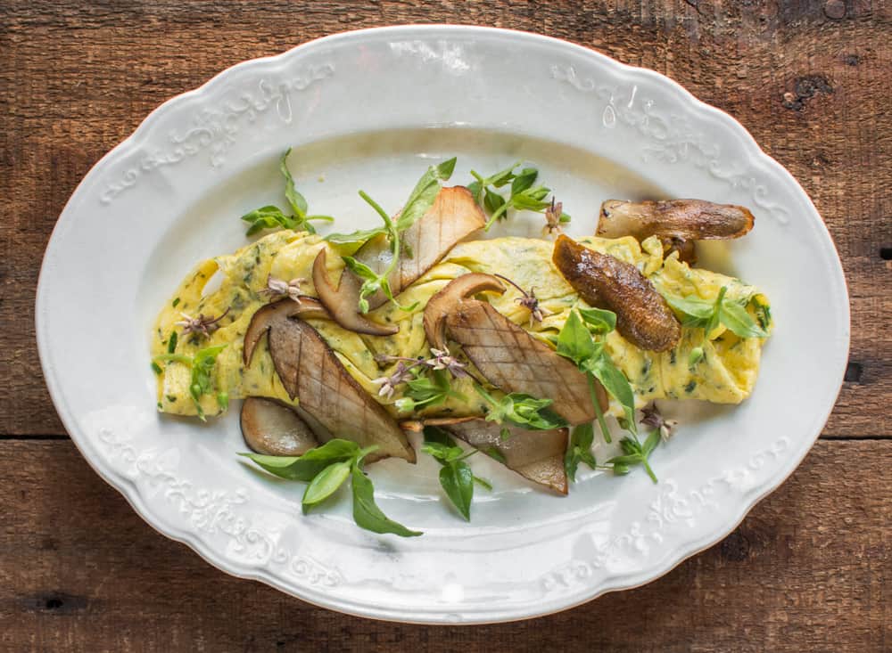 Duck egg-riccota omelet with pine boletes, chickweed, milkweed flowers and herbs ,