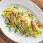 Duck egg-riccota omelet with pine boletes, chickweed, milkweed flowers and herbs ,