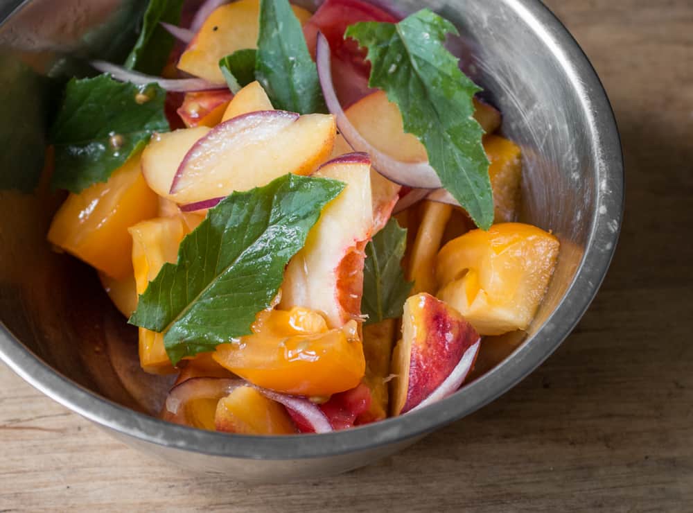 Tomato and peach salad with Erechtites hieraciifolius burnweed fireweed