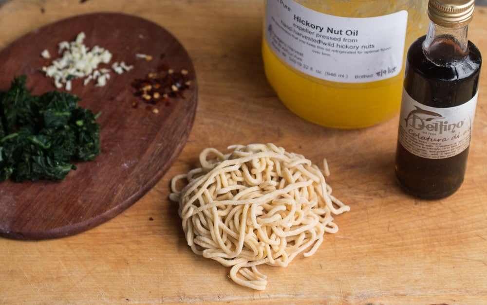 Fresh spaghetti with colatura di alici, virgina waterleaf and hickory nut oil