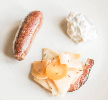 Lamb heart sausage with wild caraway, fermented root vegetables and wild horseradish cream
