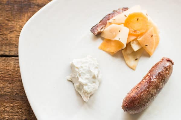 Lamb heart sausage with wild caraway, fermented root vegetables and wild horseradish cream 