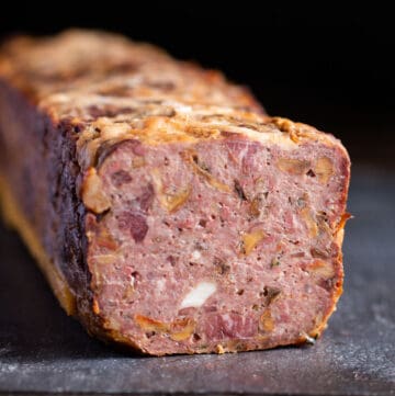 a cooked sliced terrine on a piece of slate