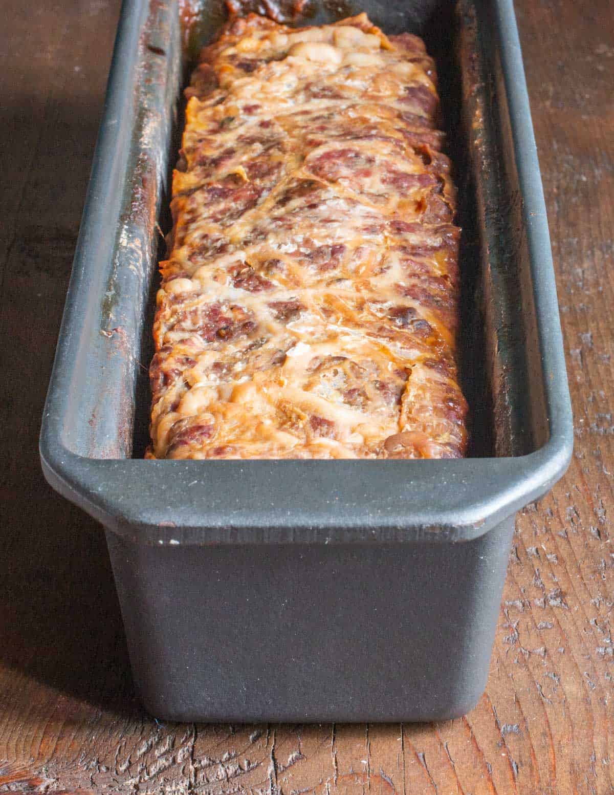 a cooked terrine wrapped in caul fat in a mold