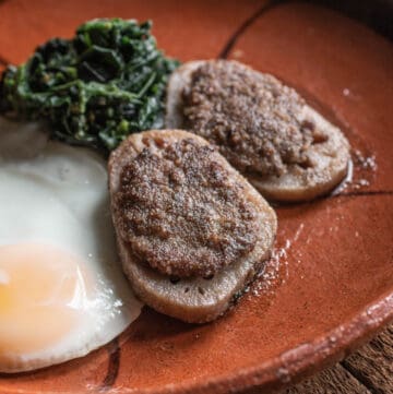 Fried lotus root stuffed wtih sausage on a plate with eggs