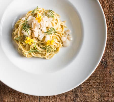duck egg spaghetti with cattail pollen, cattail shoot relish and edible marigolds