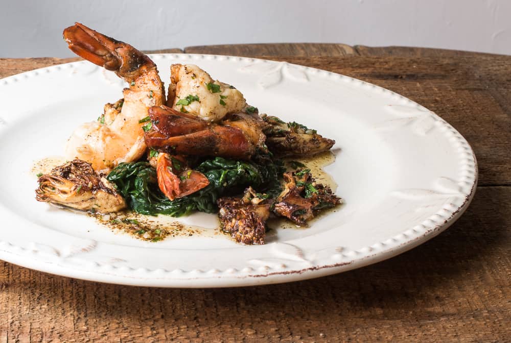 Seared prawns with coral or ramaria mushrooms, heirloom garlic butter sauce and lacinato kale 