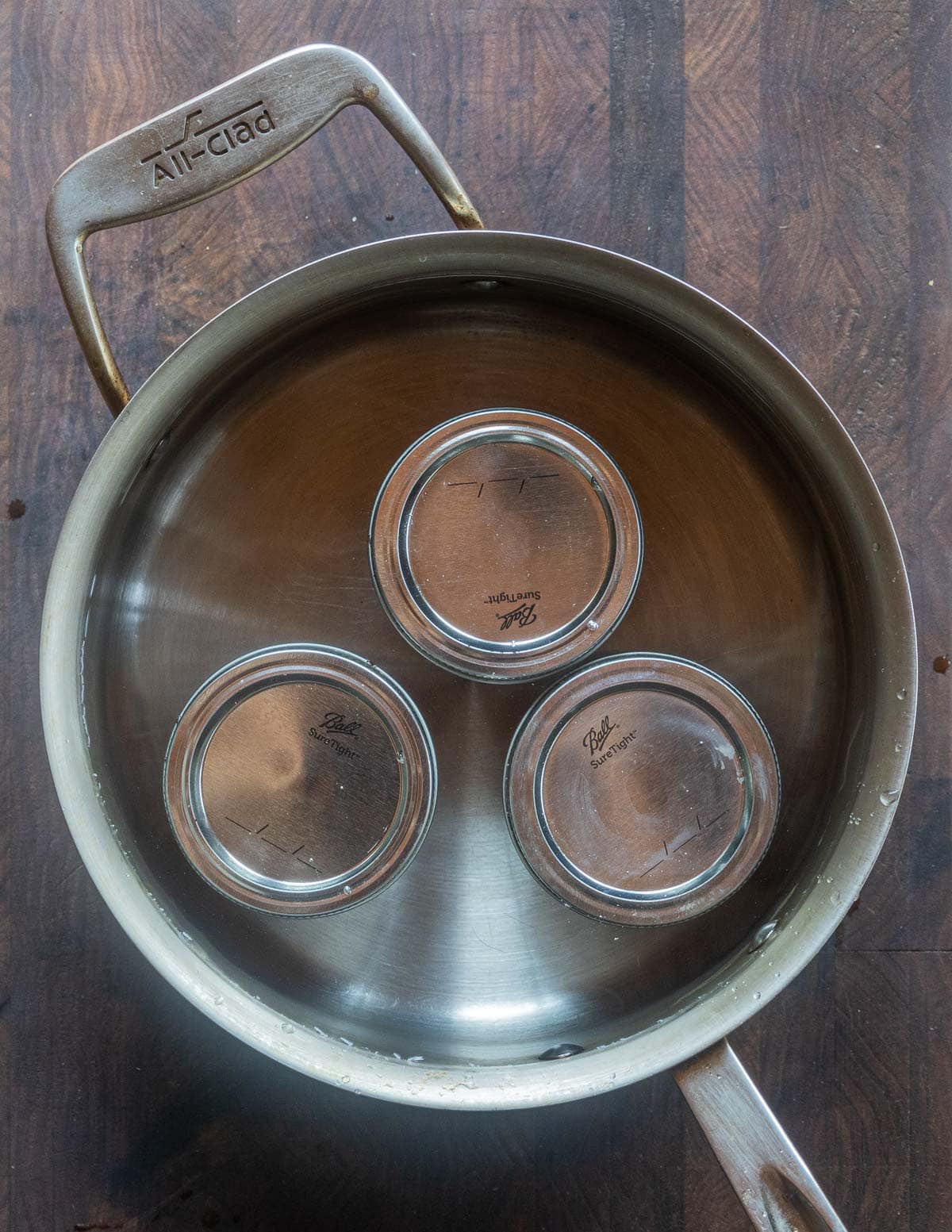 Canning Jars of wild plum jam in a water bath canner. 