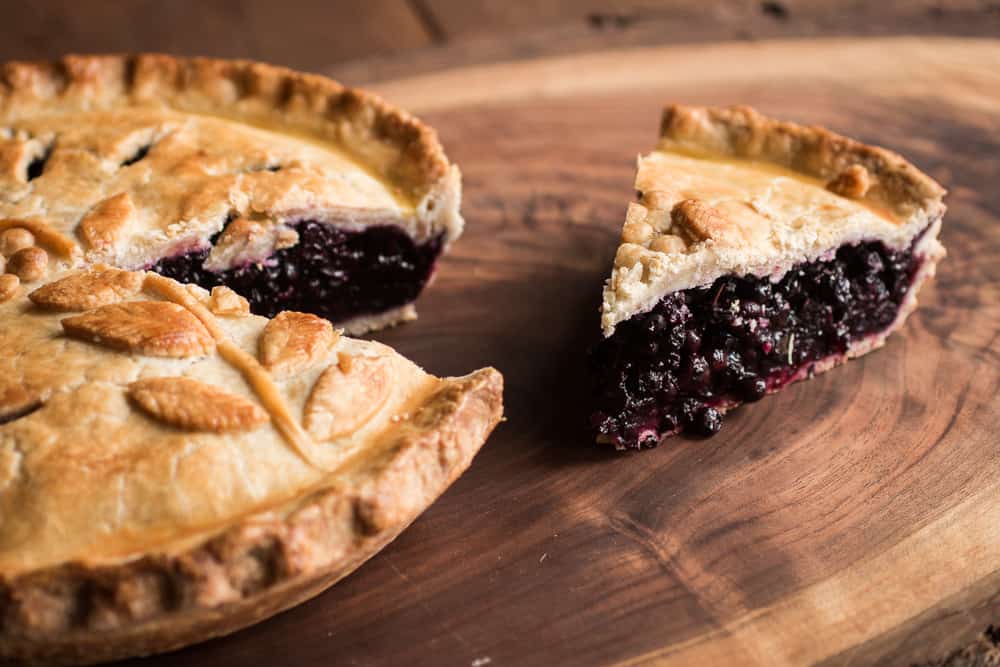 wild blueberry pie with a slice cut out 