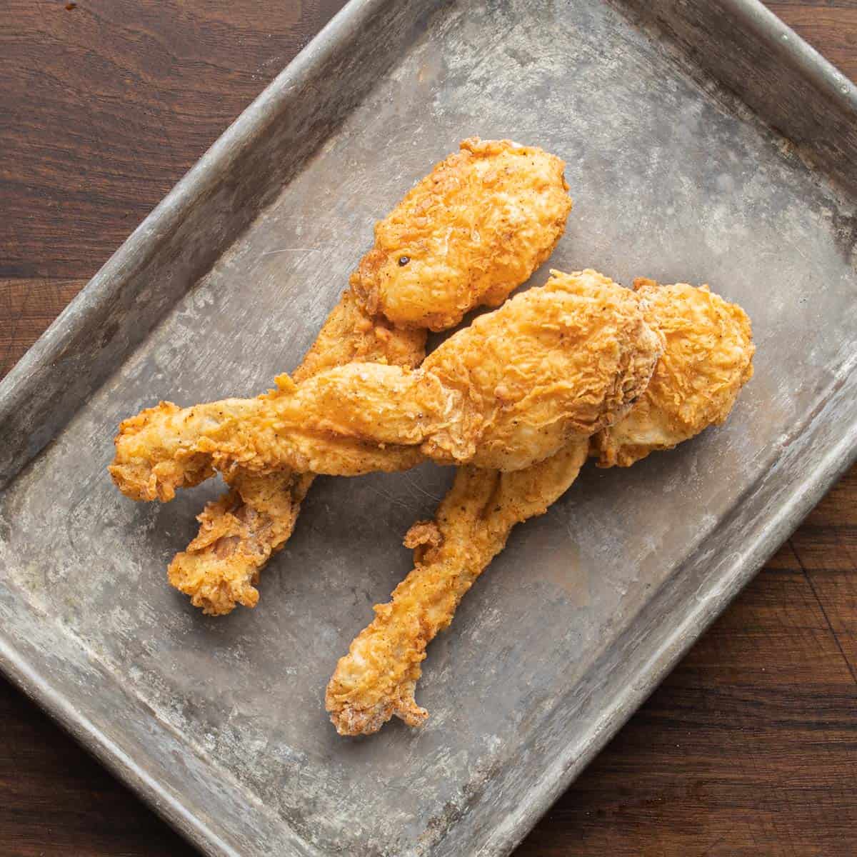 fried frog legs on a tray
