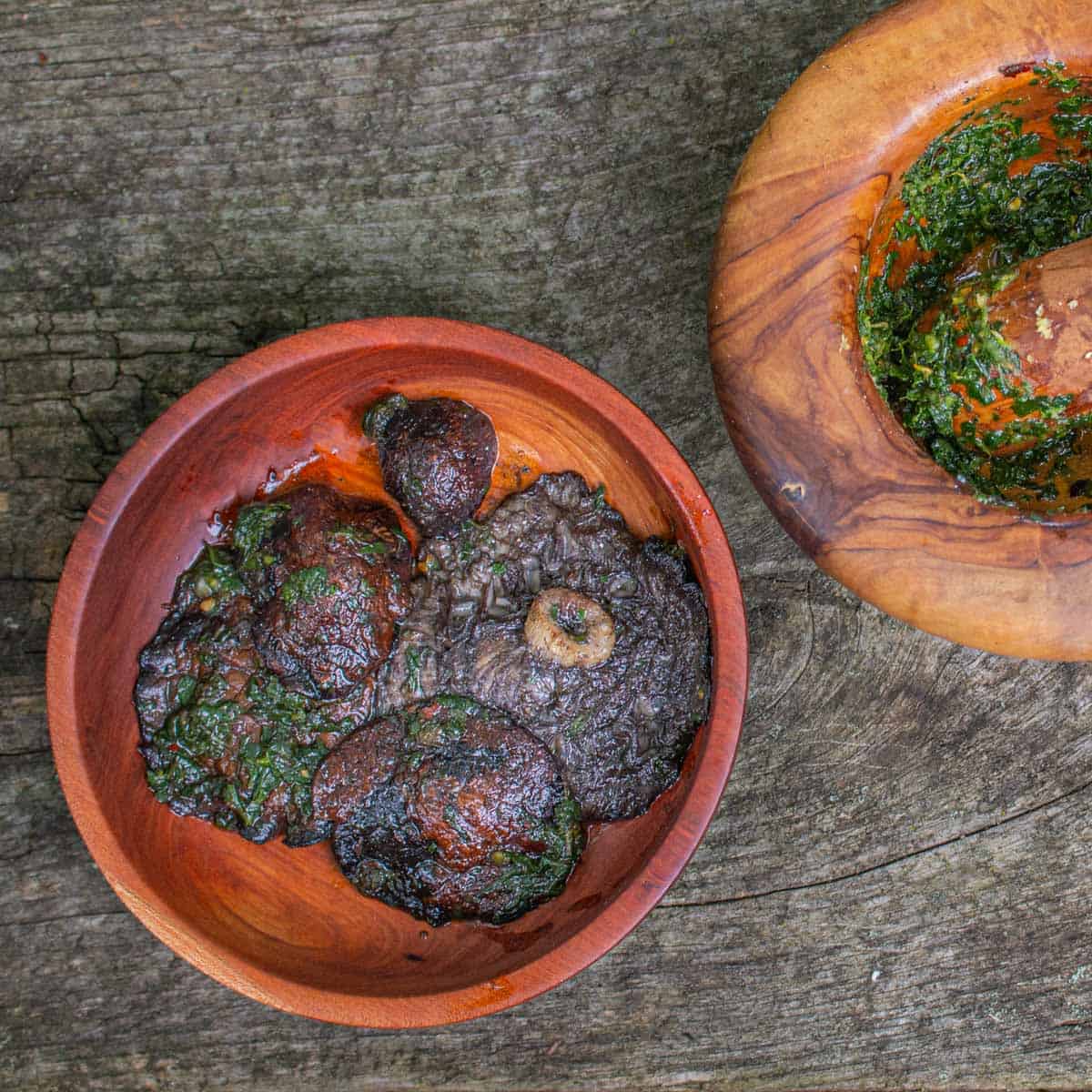 Stropharia or wine cap mushrooms cooked in embers with crushed parsley and garlic sauce