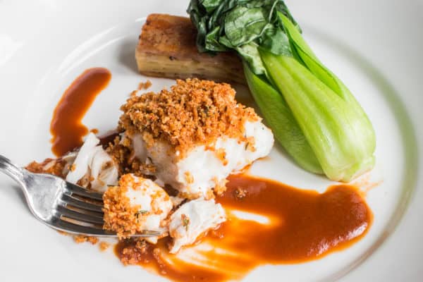 Skrei cod baked with lobster mushroom breadcrumbs, lobster sauce, potato pave and bok choy