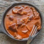 cooked mushrooms in a pan with tomato