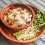 Vietnamese style noodle soup with coral mushrooms, chicken and rue ram