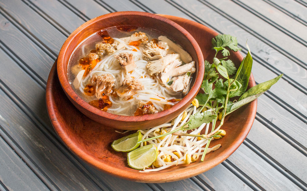 Vietnamese style noodle soup with coral mushrooms, chicken and rue ram