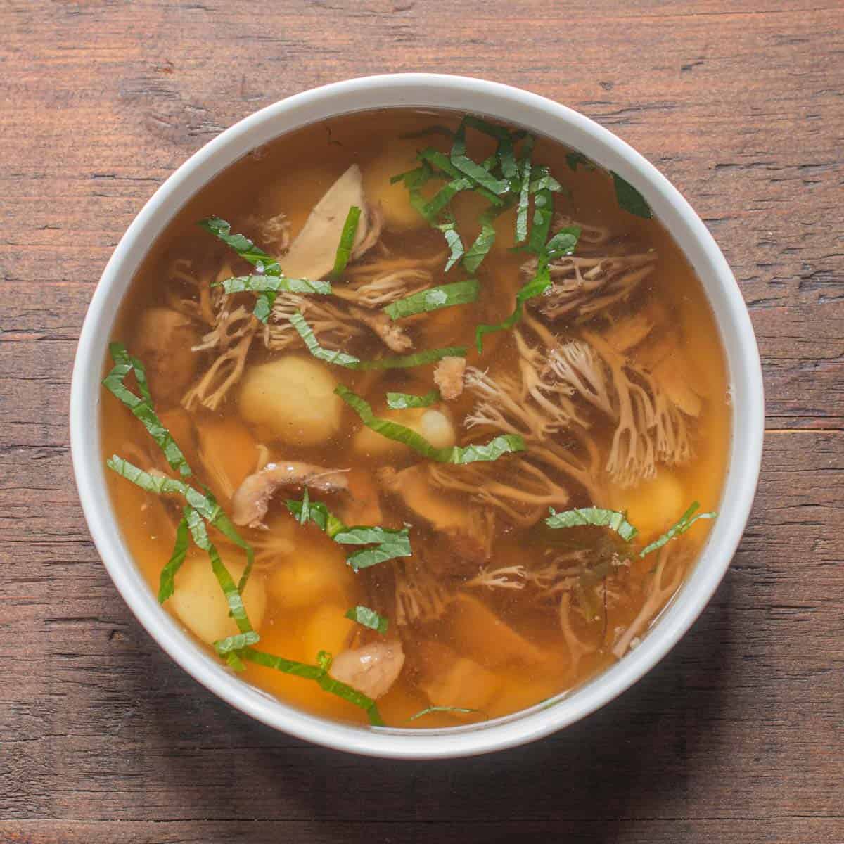 Crown coral mushrooms in broth with mitsuba and squirrel confit