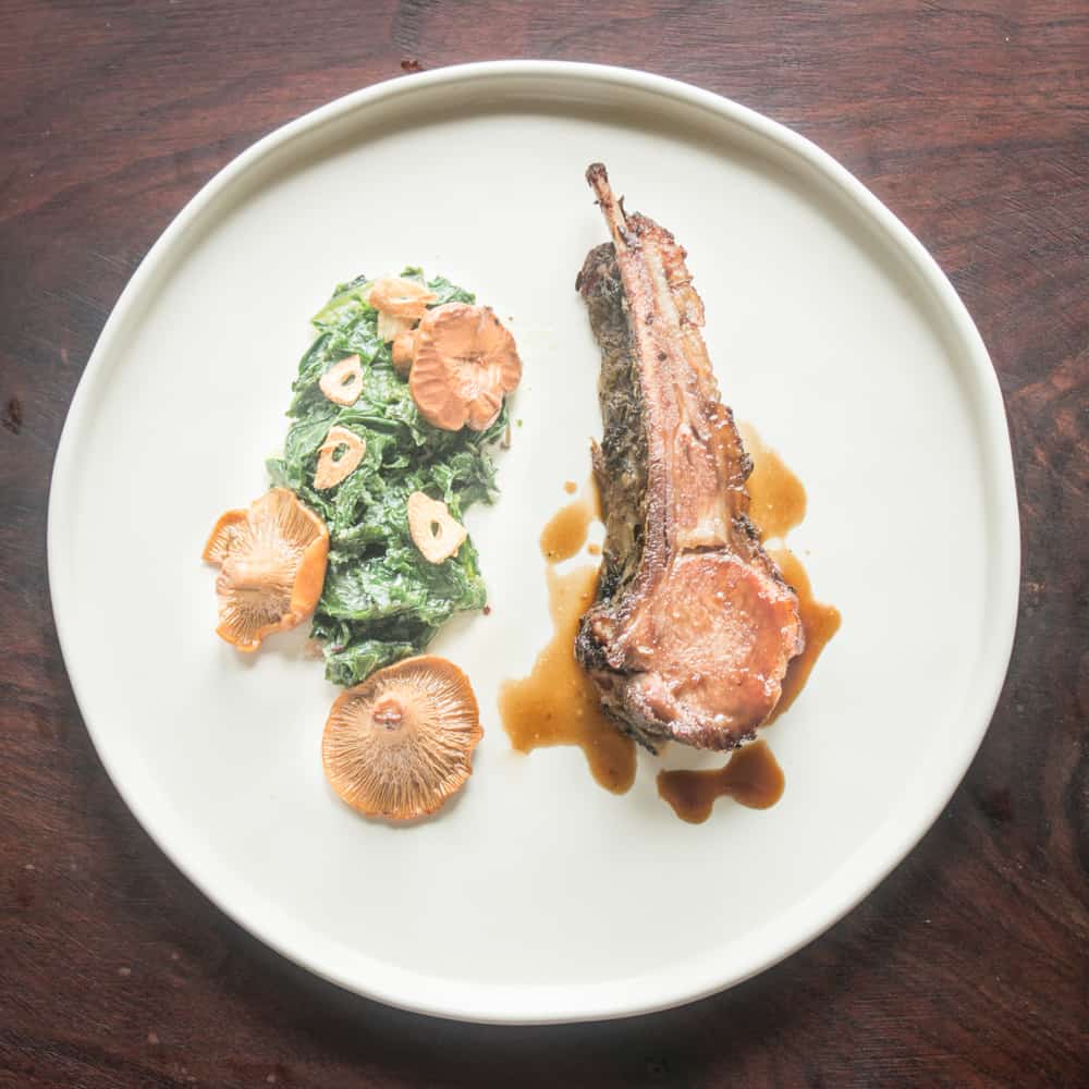 Slow roasted rack of lamb with bolete crust, jus, spinach and chanterelles