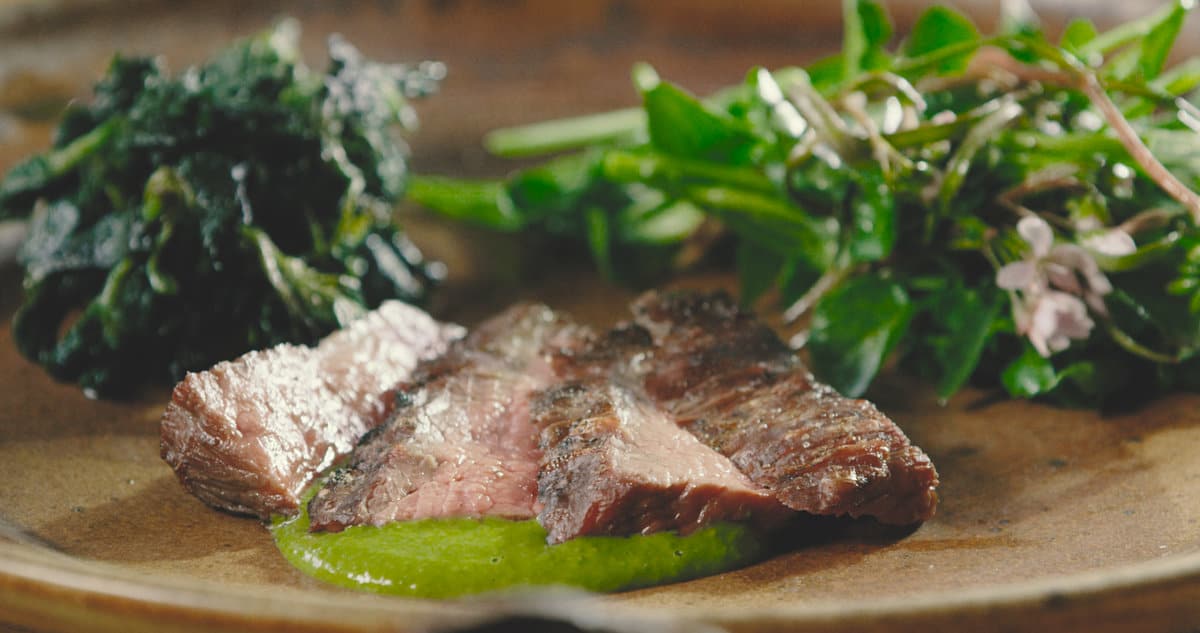 Pastured beef flank steak with ramp leaf salsa verde, glazed nettles, spring beauty, toothwort and watercress salad