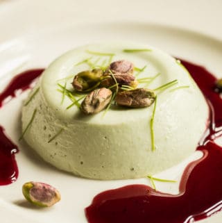 Spruce tip panna cotta recipe with wild grape sauce and pistachios