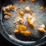Boiling chanterelle mushrooms in water before sauteeing