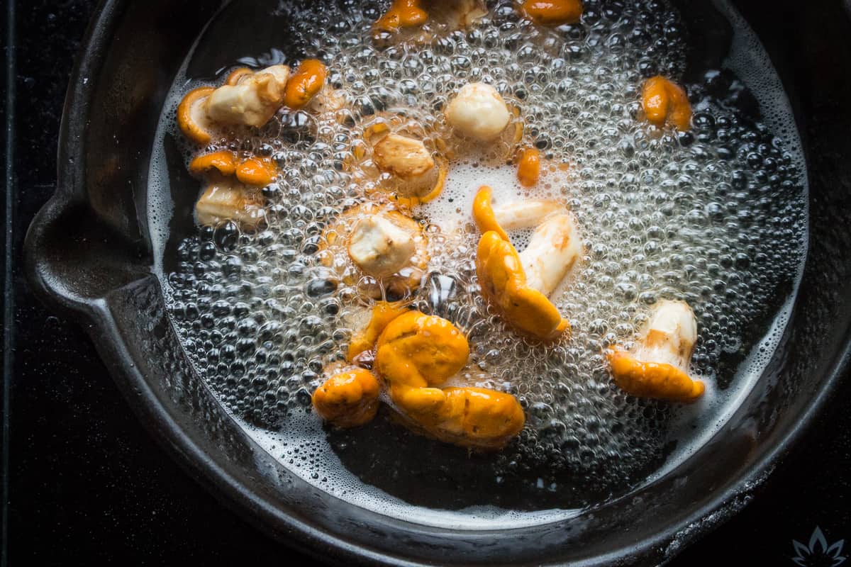 Boiling chanterelle mushrooms in water before sauteeing 