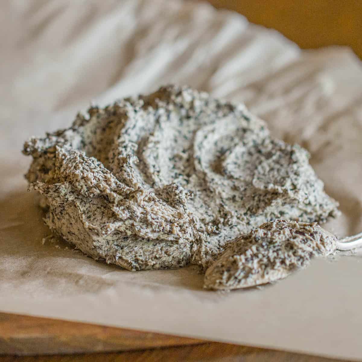 spreading out mushroom butter on a board 