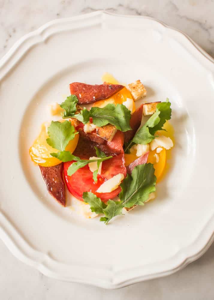 Beefsteak mushroom salad with tomatoes, arugula, and parmesan