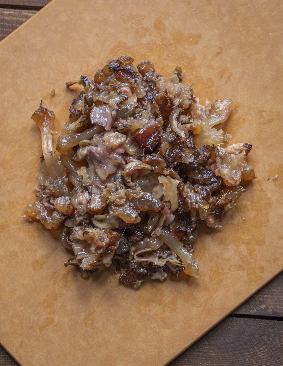 Very finely cooked venison trotter meat on a cutting board. 