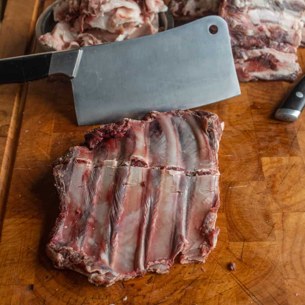 cutting venison ribs with a cleaver